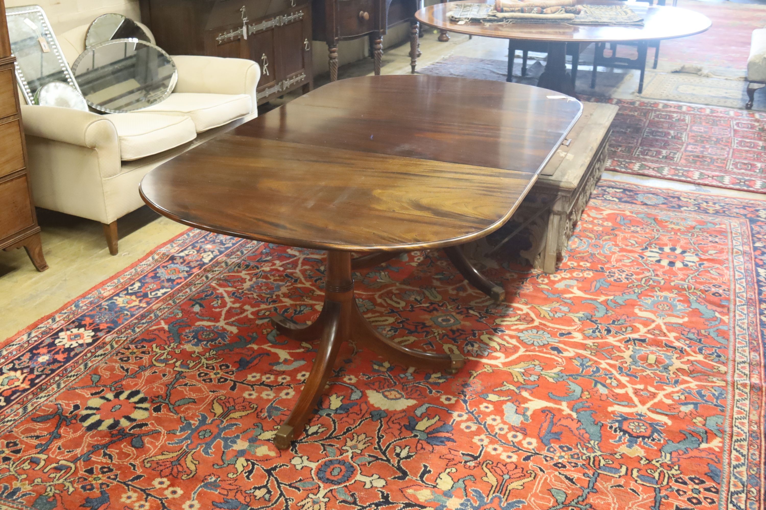 A William Tillman style reproduction mahogany twin pillar extending dining table, 186cm extended, (one spare leaf) width 106cm, height 73cm